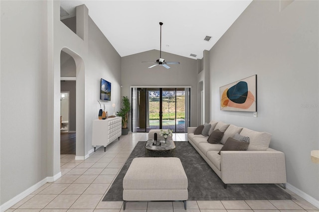 tiled living room featuring ceiling fan and high vaulted ceiling