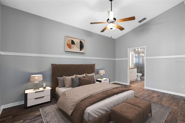 bedroom featuring dark hardwood / wood-style flooring, ensuite bathroom, ceiling fan, and lofted ceiling