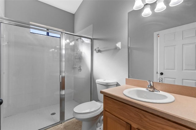 bathroom with tile patterned flooring, vanity, toilet, and a shower with door