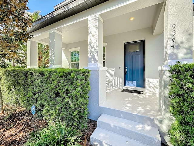 view of exterior entry with covered porch