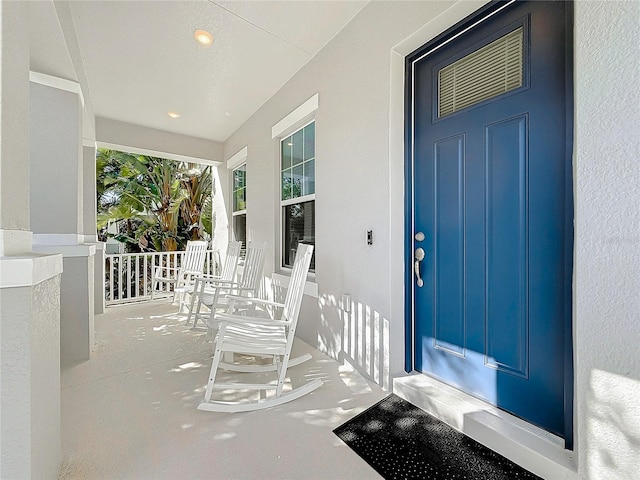 doorway to property featuring covered porch