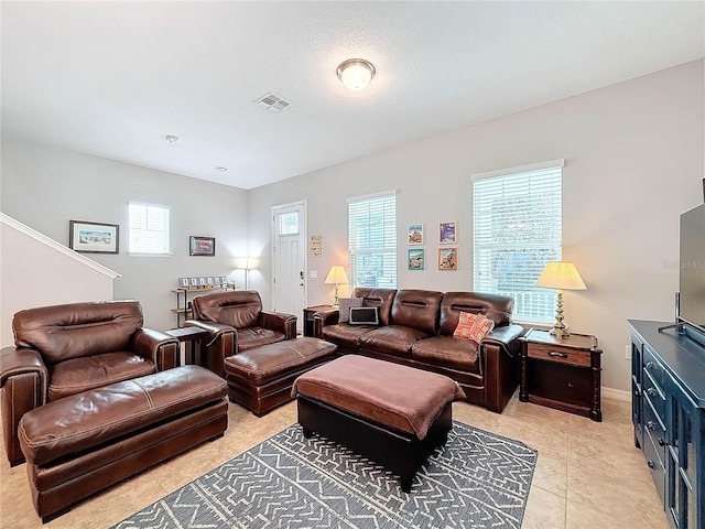 living room featuring light tile patterned floors and a healthy amount of sunlight