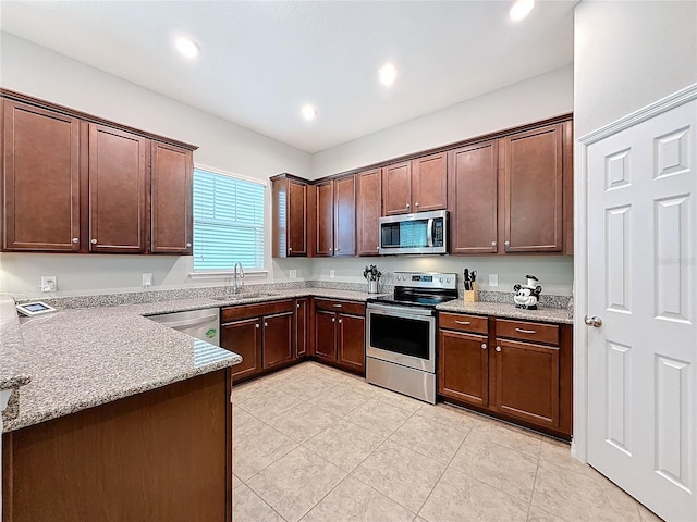 kitchen featuring sink, light tile patterned floors, light stone countertops, appliances with stainless steel finishes, and dark brown cabinets