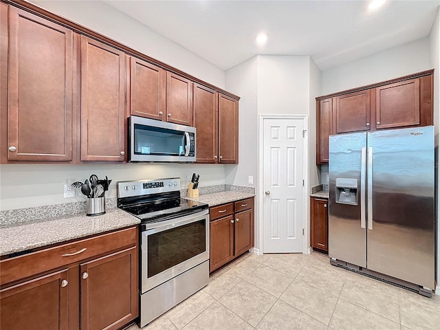 kitchen with light tile patterned floors and stainless steel appliances