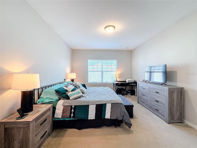 carpeted bedroom featuring multiple windows and a textured ceiling