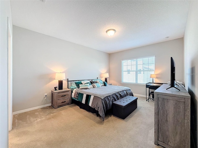 carpeted bedroom featuring a textured ceiling