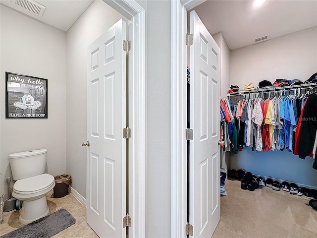 interior space with tile patterned flooring and toilet