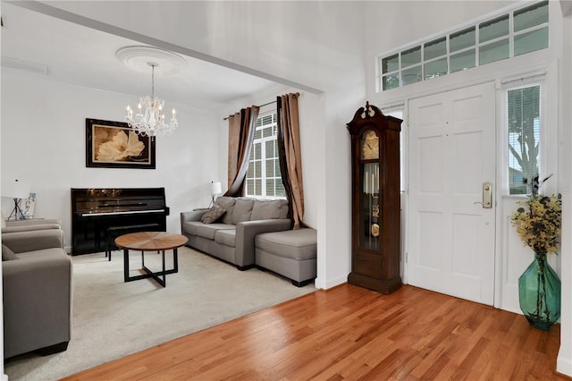 living room featuring hardwood / wood-style flooring, a notable chandelier, and a wealth of natural light