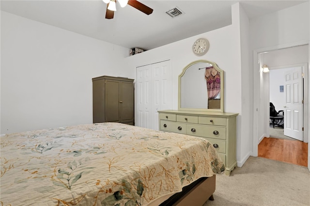 bedroom featuring light carpet, a closet, and ceiling fan