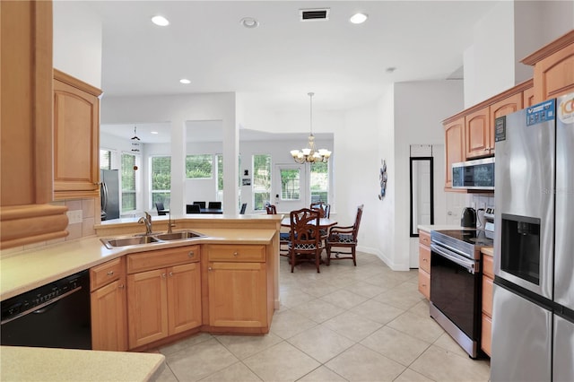 kitchen featuring stainless steel appliances, sink, an inviting chandelier, hanging light fixtures, and light tile patterned flooring