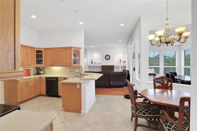 kitchen with sink, black dishwasher, backsplash, kitchen peninsula, and pendant lighting