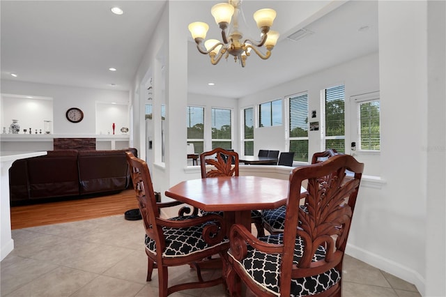 dining room featuring a chandelier and light tile patterned flooring