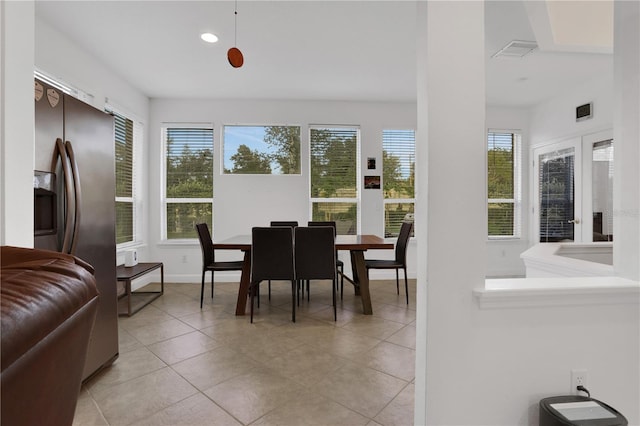 dining area featuring plenty of natural light and light tile patterned floors