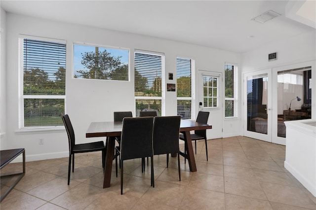 tiled dining area featuring french doors