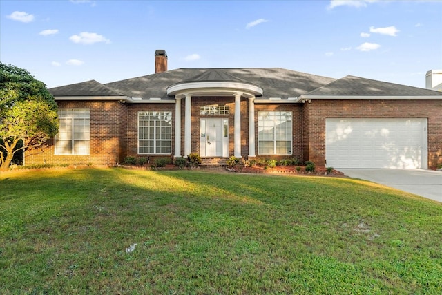 ranch-style house with a garage and a front yard