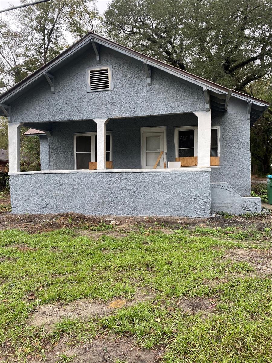 back of property featuring a porch