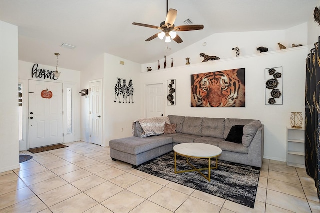 living room featuring ceiling fan, light tile patterned floors, and vaulted ceiling