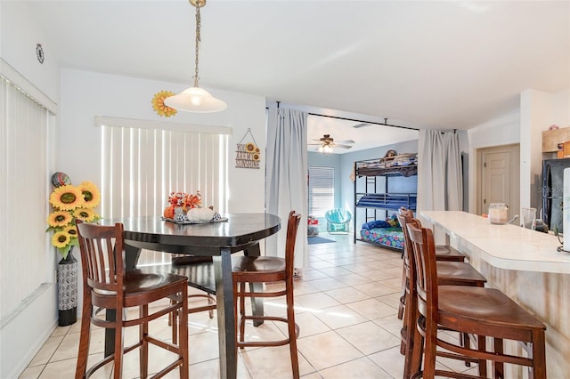 tiled dining room featuring ceiling fan