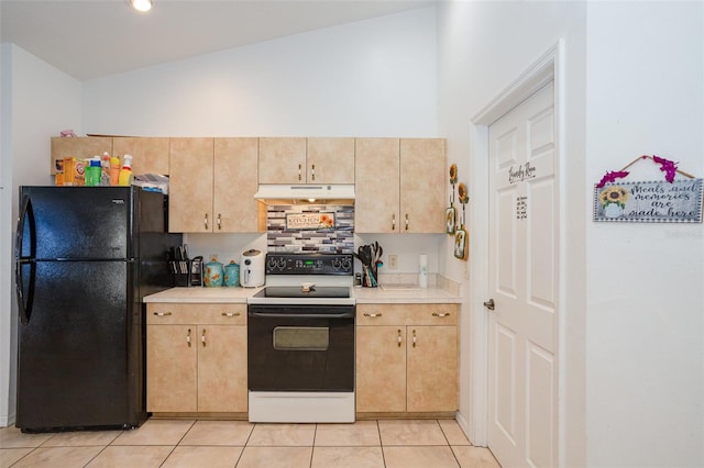 kitchen with light brown cabinetry, black fridge, light tile patterned floors, white range with electric cooktop, and lofted ceiling