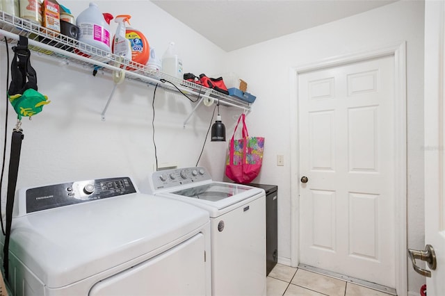 laundry room featuring washer and clothes dryer and light tile patterned flooring