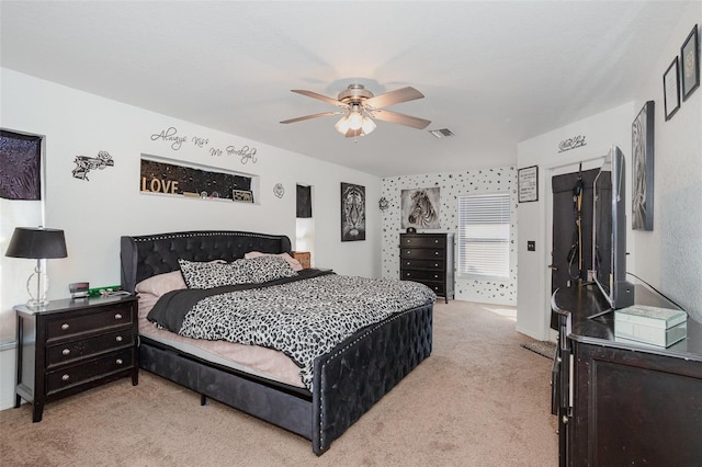 bedroom featuring ceiling fan and light carpet