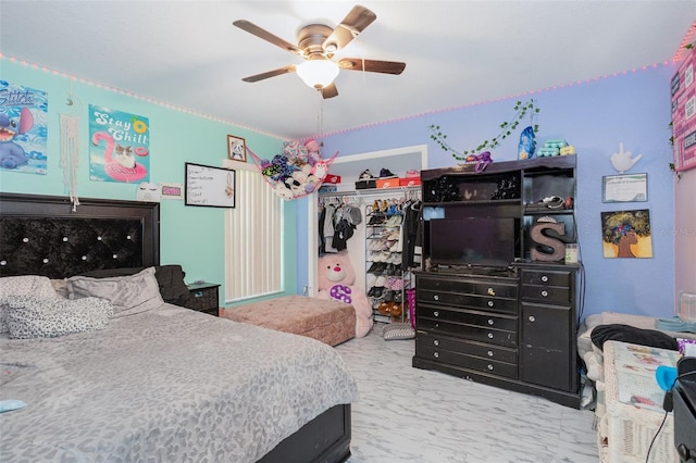 bedroom with ceiling fan and a closet