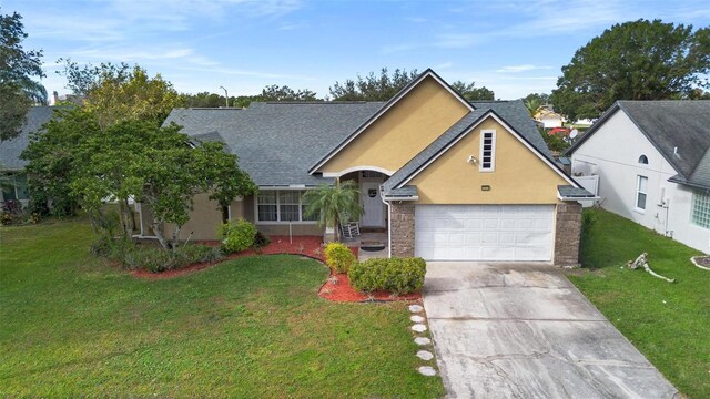 12512 Tillingham Ct SW, Orlando, FL 32837 - view of front facade featuring concrete driveway, a front lawn, stucco siding, and a garage