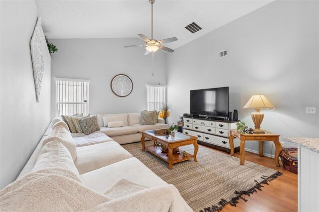 12512 Tillingham Ct SW, Orlando, FL 32837 - living area with a ceiling fan, light wood-style flooring, and high vaulted ceiling
