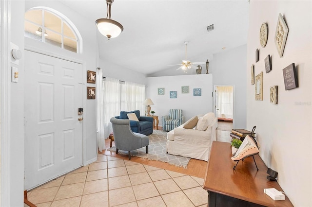12512 Tillingham Ct SW, Orlando, FL 32837 - entrance foyer with light tile patterned floors, ceiling fan, and high vaulted ceiling