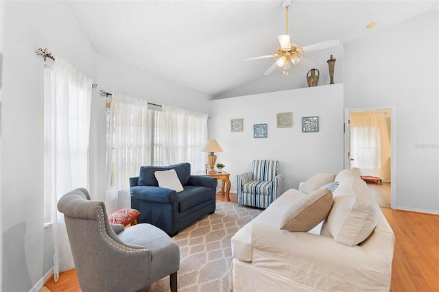 living room featuring ceiling fan, hardwood / wood-style floors, and lofted ceiling