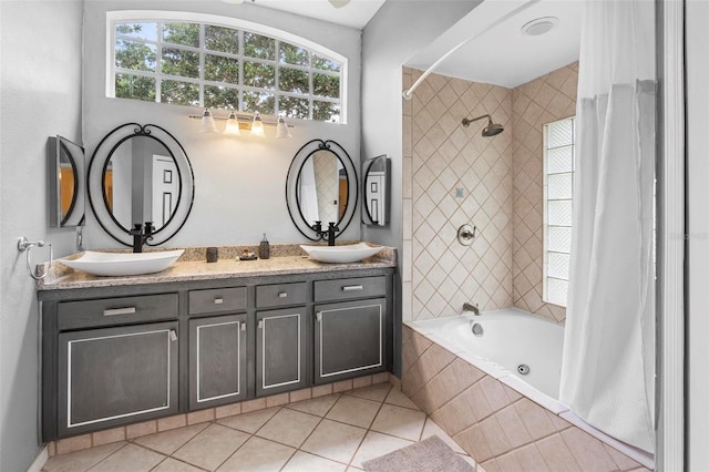 12512 Tillingham Ct SW, Orlando, FL 32837 - full bath with tile patterned floors, tiled shower / bath, and double vanity