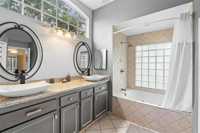 bathroom featuring tile patterned flooring, plenty of natural light, shower / bathtub combination with curtain, and vanity