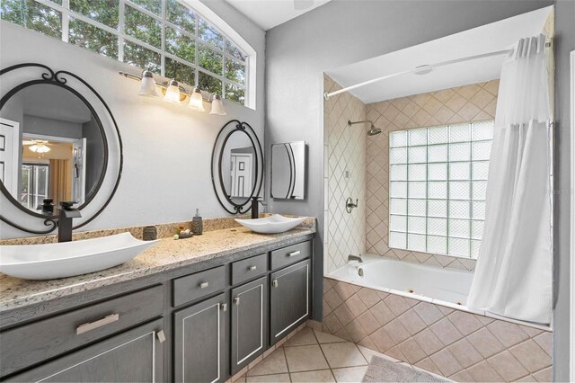 12512 Tillingham Ct SW, Orlando, FL 32837 - bathroom featuring tiled shower / bath, tile patterned flooring, ceiling fan, and double vanity