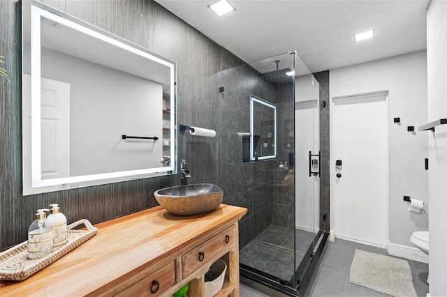 bathroom with walk in shower, tile patterned floors, vanity, and toilet