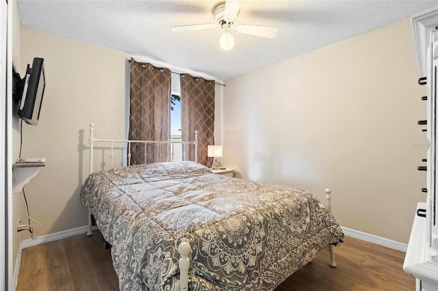 bedroom with ceiling fan, hardwood / wood-style floors, and a textured ceiling