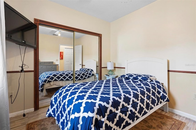 bedroom with hardwood / wood-style flooring and a closet