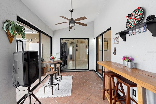 office space featuring tile patterned flooring, ceiling fan, and lofted ceiling