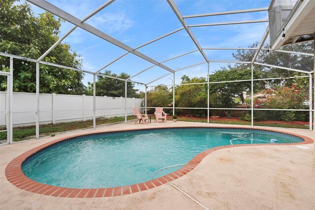 12512 Tillingham Ct SW, Orlando, FL 32837 - view of swimming pool with a patio, a fenced backyard, and glass enclosure