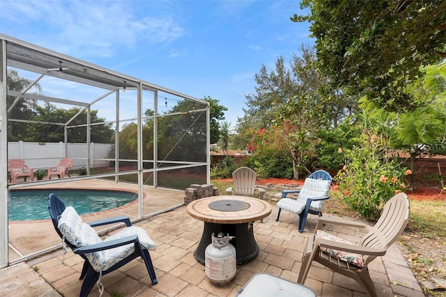 view of patio with a fenced in pool, an outdoor fire pit, and a lanai