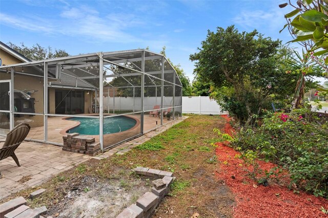 12512 Tillingham Ct SW, Orlando, FL 32837 - view of pool with a fenced backyard, a patio, and a lanai