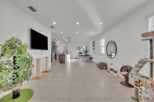 living room with light tile patterned floors and a wealth of natural light