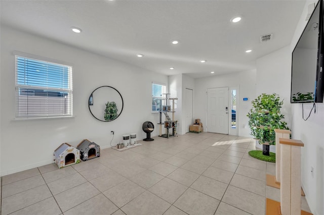 workout room featuring light tile patterned floors and a wealth of natural light