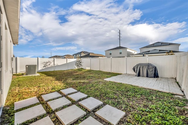 view of yard featuring cooling unit and a patio area