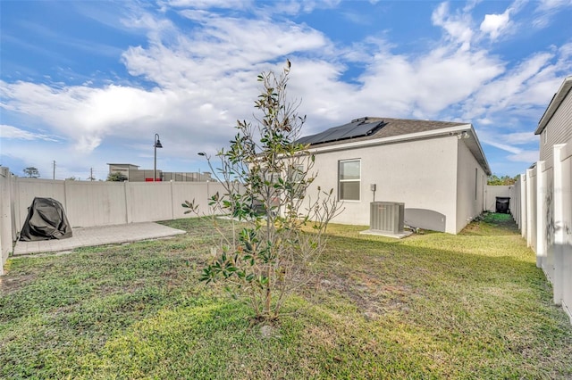 view of yard with central AC and a patio area