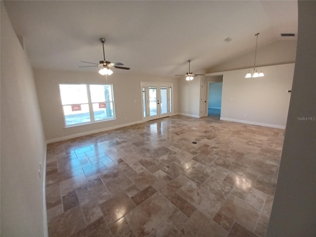 spare room with vaulted ceiling, french doors, and ceiling fan with notable chandelier