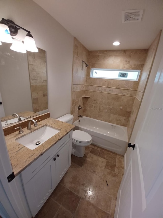 bathroom featuring visible vents, vanity, toilet, and shower / tub combination