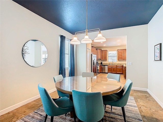 dining area with light tile patterned flooring and sink