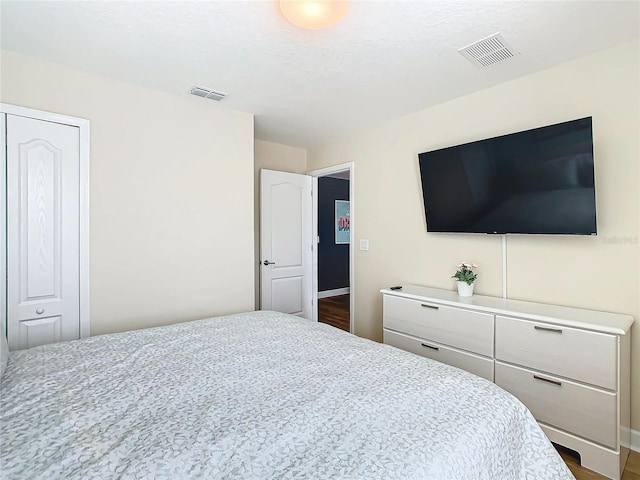 bedroom with a closet and dark wood-type flooring