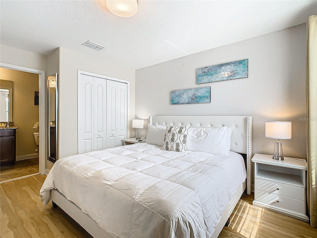 bedroom with light hardwood / wood-style flooring and a closet