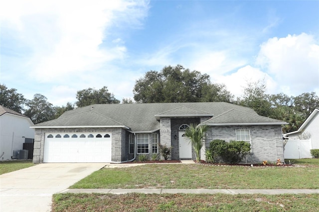 single story home featuring a garage, central AC, and a front lawn